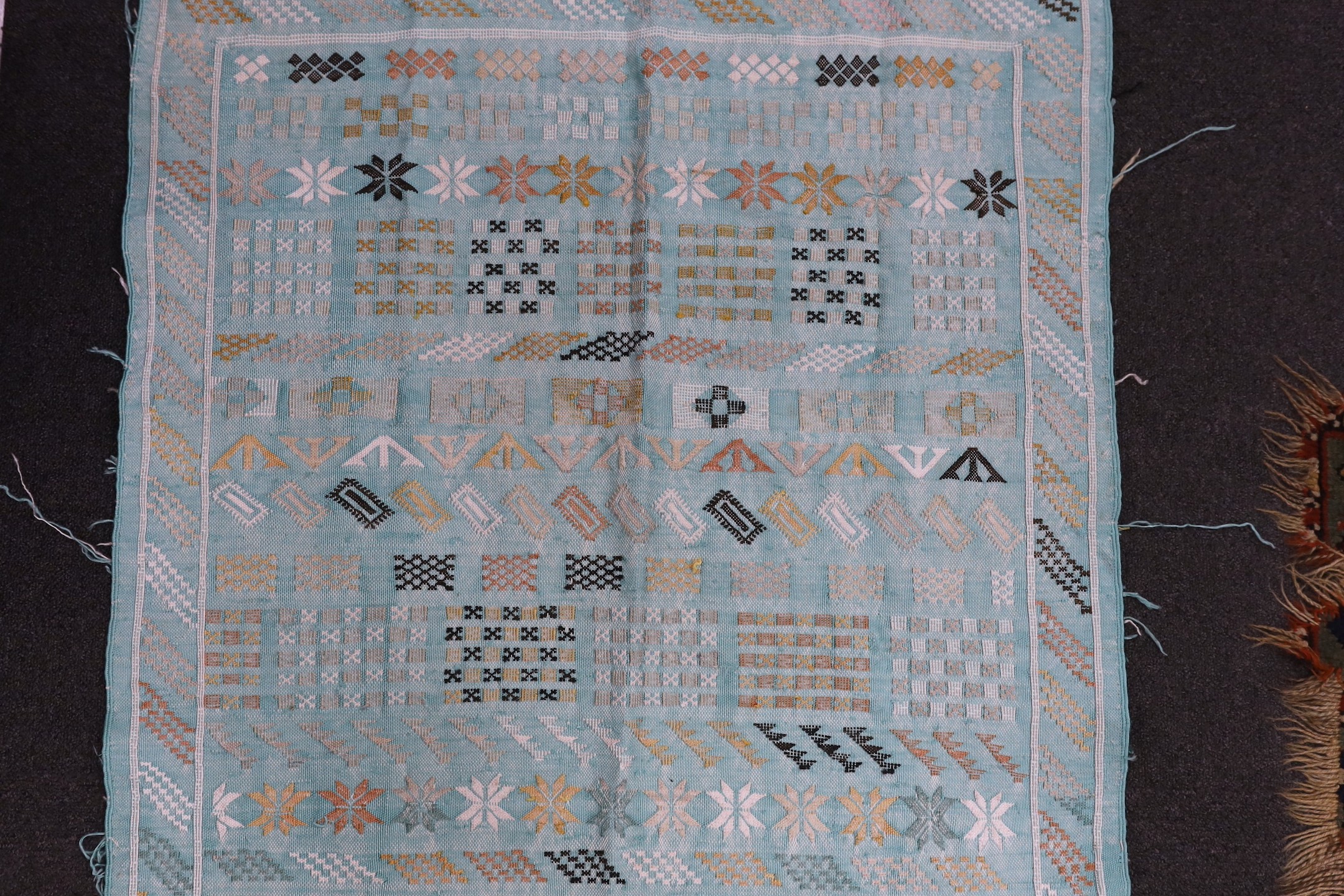 A turquoise rug, possibly Scandinavian